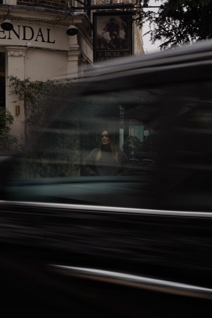 Street portrait in South Kensington with a passing car blurred in the foreground